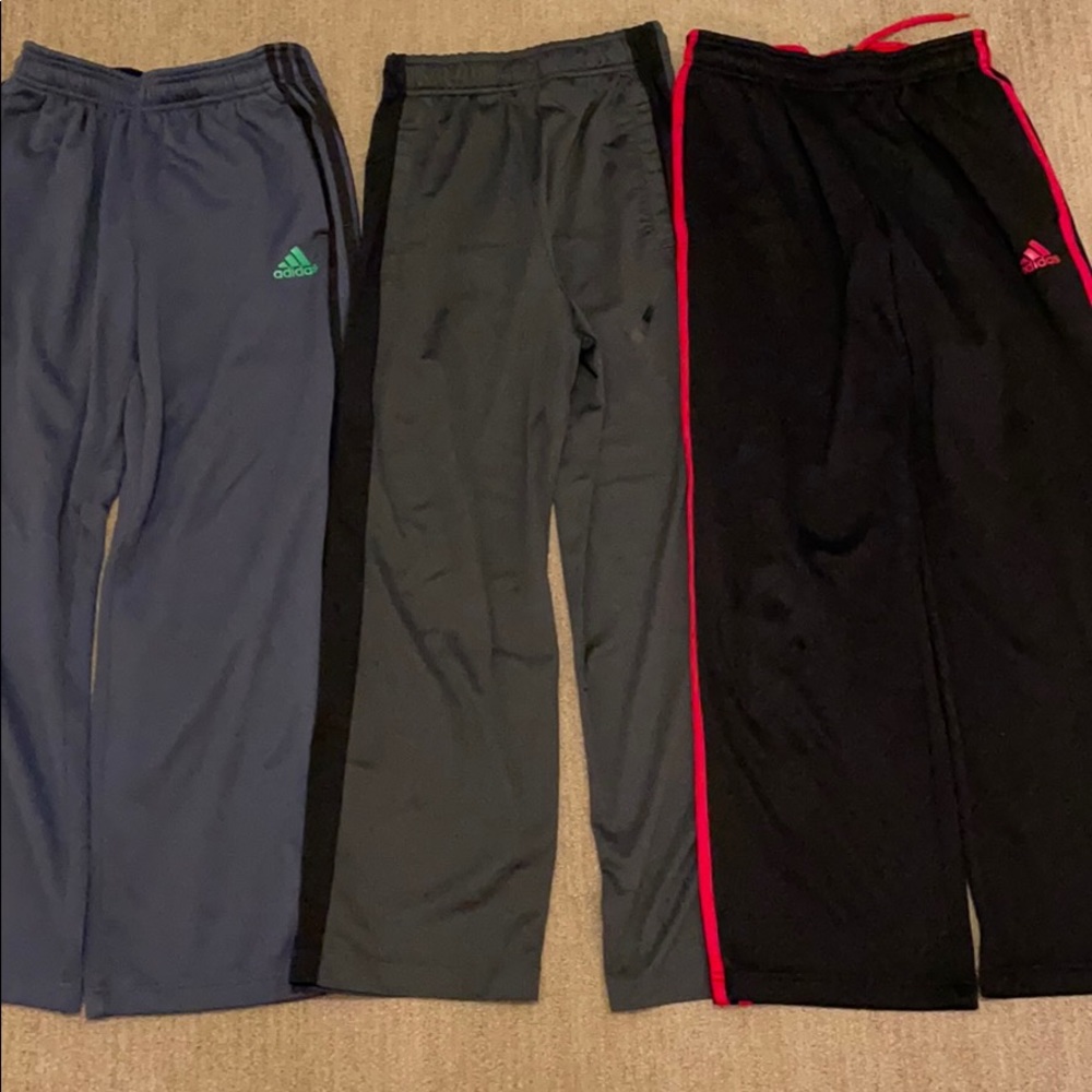 Three sports pants. Two Adidas, one Nike